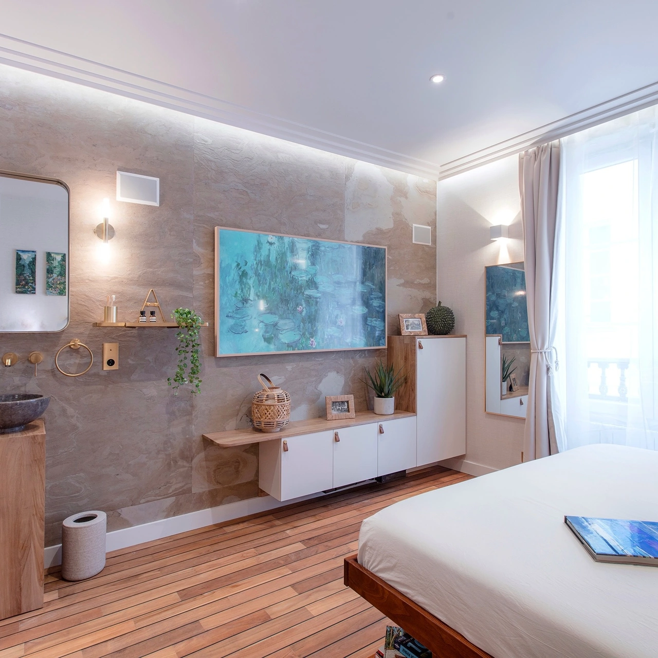 Bedroom with teak flooring, stone basin and brass wall lights