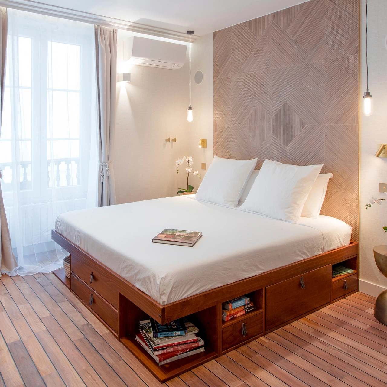 Wide view of the bedroom with a king-size bed and teak flooring