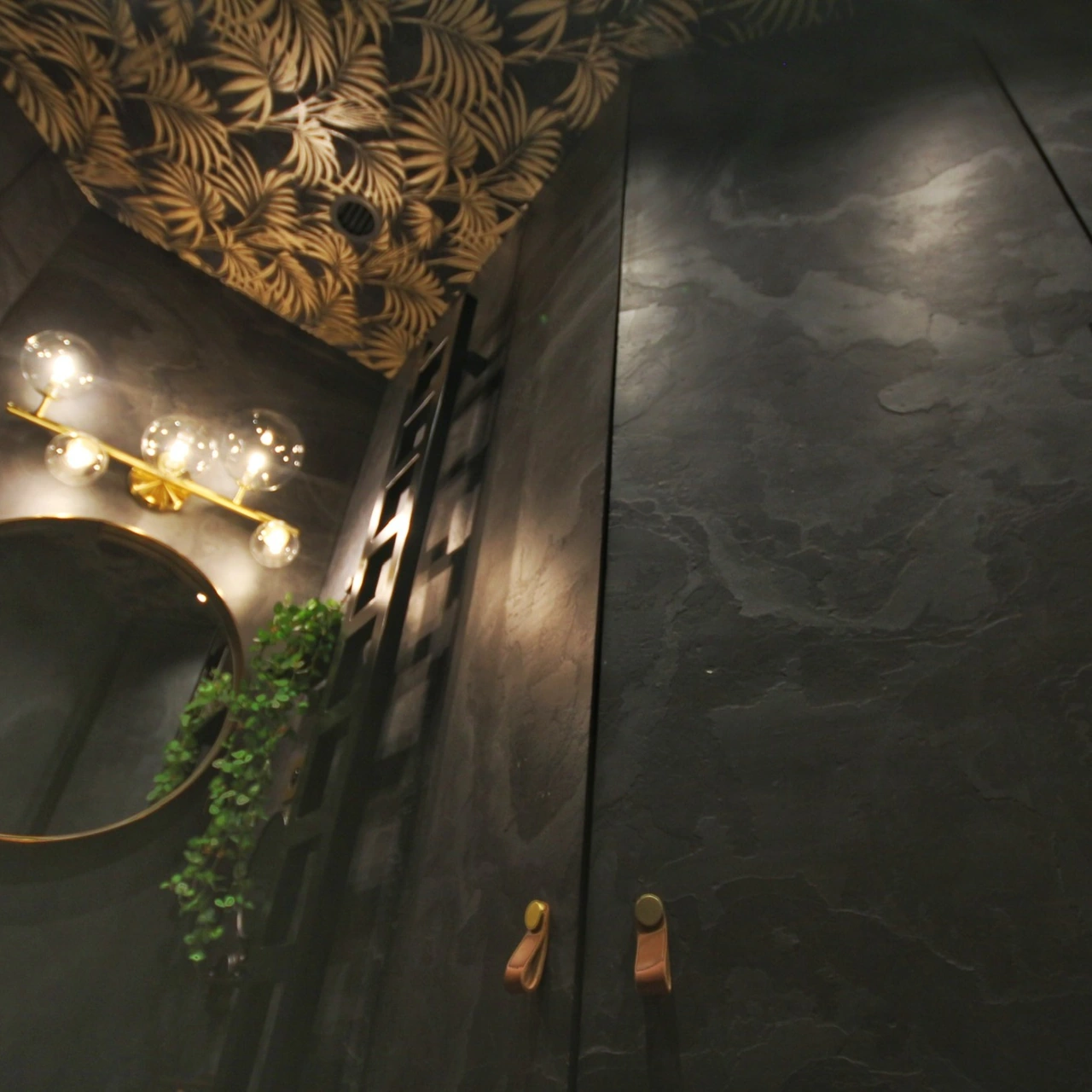 Detail of the botanical ceiling patterns and round mirror