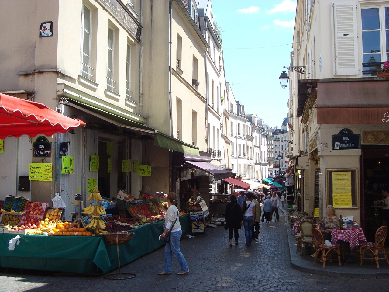 Food shops, fruit stalls and café terraces on Rue Mouffetard in the Latin Quarter of Paris